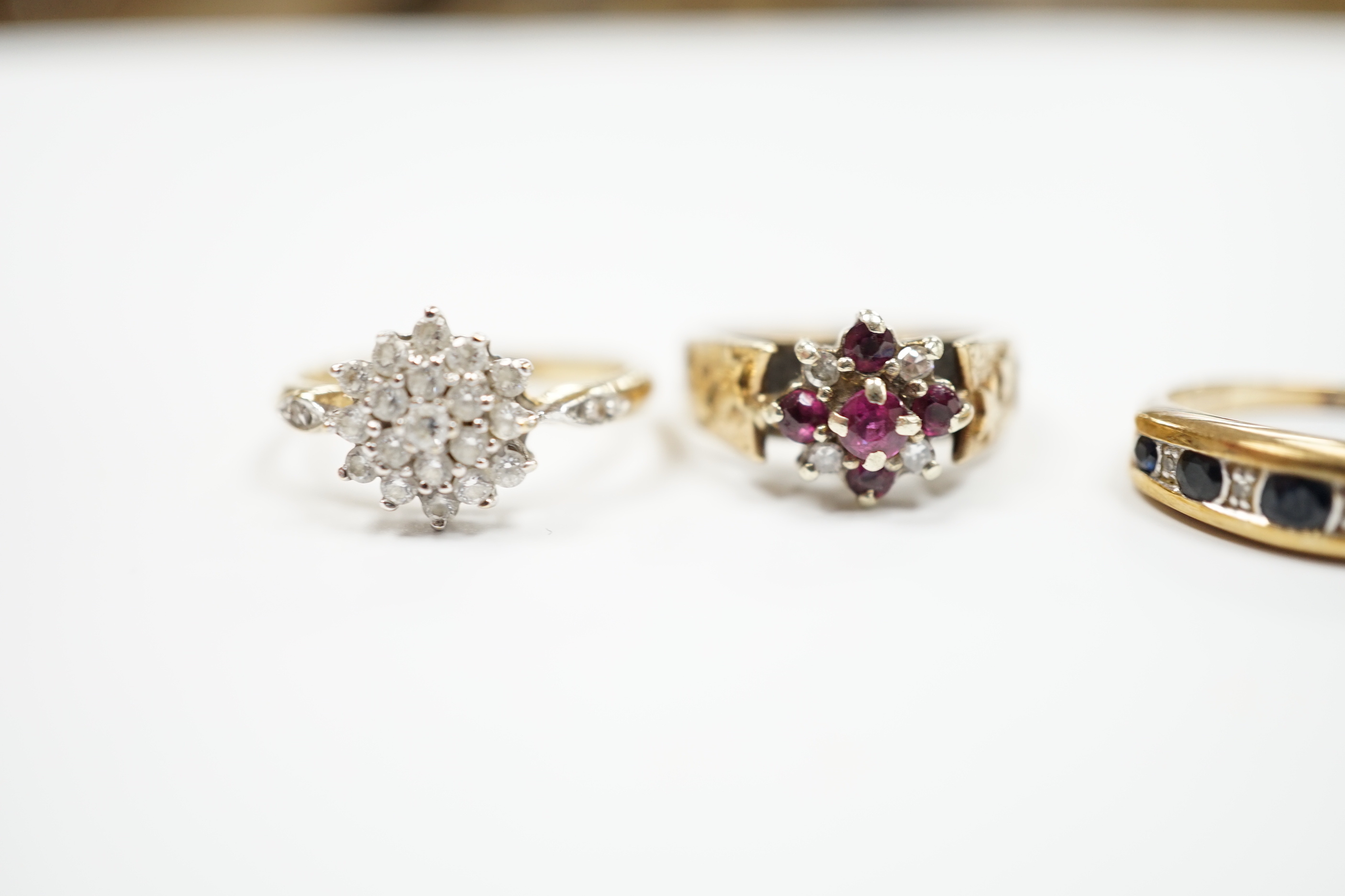 Three assorted 9ct gold and gem set rings, including ruby and diamond cluster, gross weight 7.7 grams, a 585 yellow metal and cubic zirconia set cluster ring and a yellow metal, garnet and seed pearl set ring, gross weig